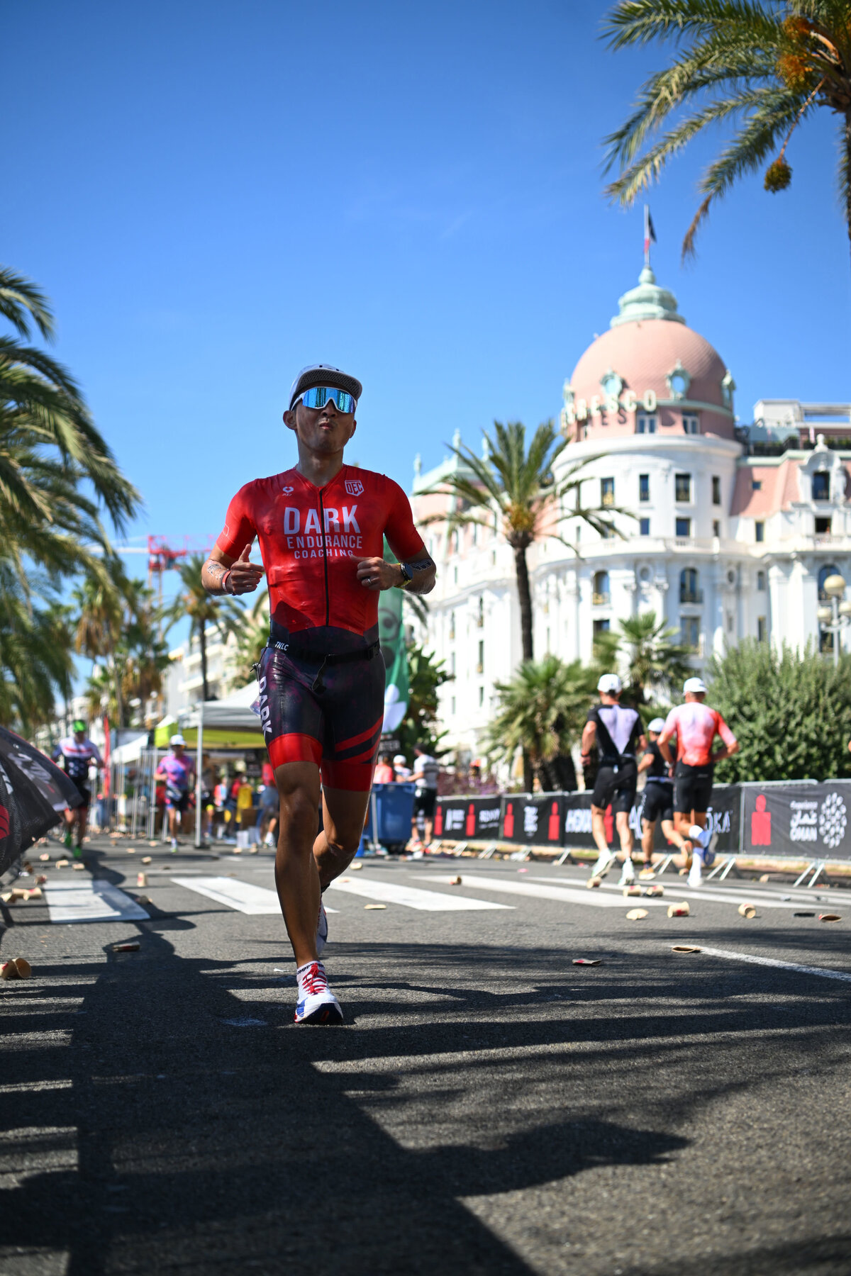 Nick Hsieh on the run course at the 2026 IRONMAN 70.3 World Championship, Promenade des Anglais, Nice — Dark Endurance Coaching kit